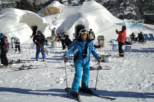 A skier at a resort in the snowy mountains