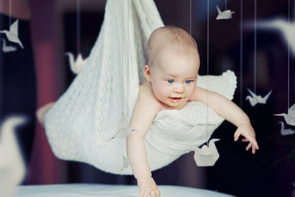 A gentle baby in a floating cradle