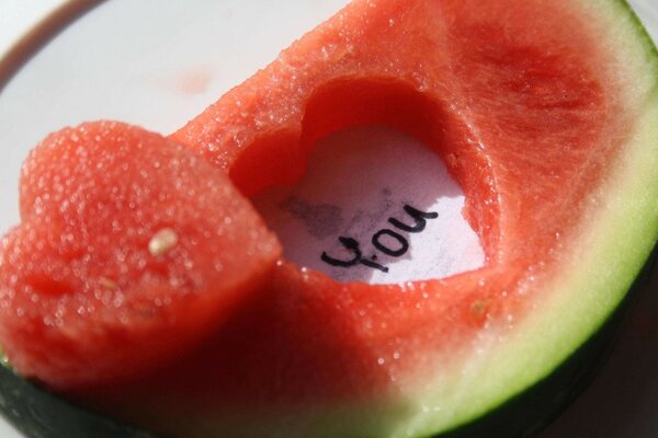 A piece of watermelon with a heart