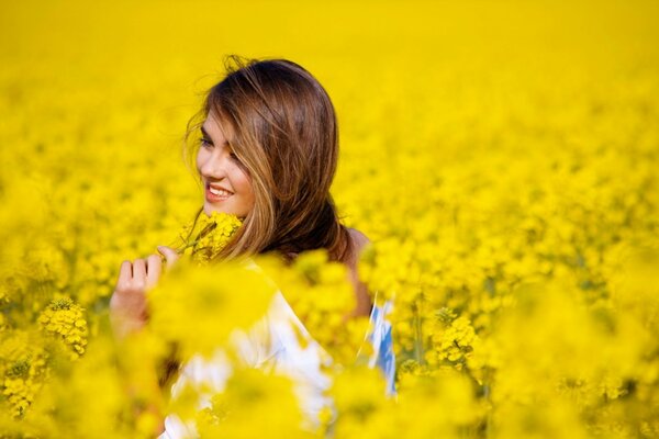 A girl in a field with yellow flowers