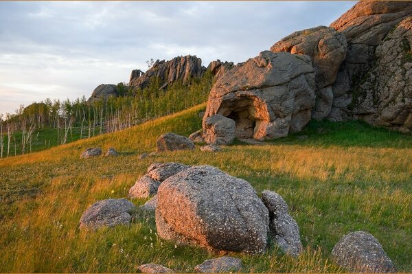 Stone boulders on the green grass