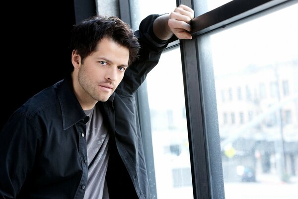 Misha Collins poses near the window