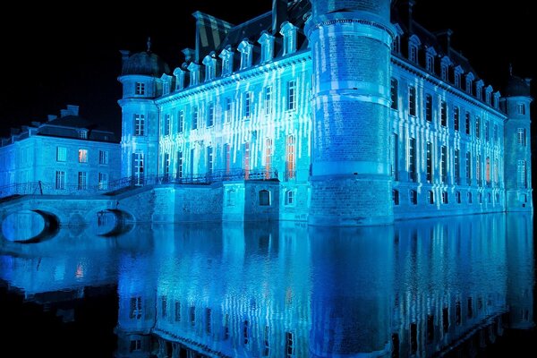 A house on the water with a blue backlight