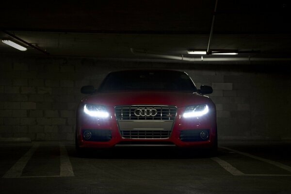 Flashing neon headlights of a red car in the subway