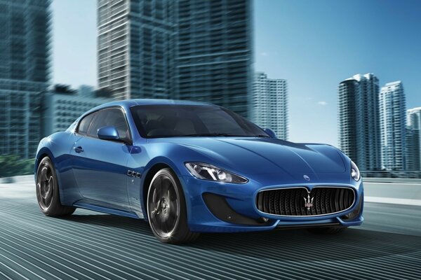 A blue sports car flying along the highway