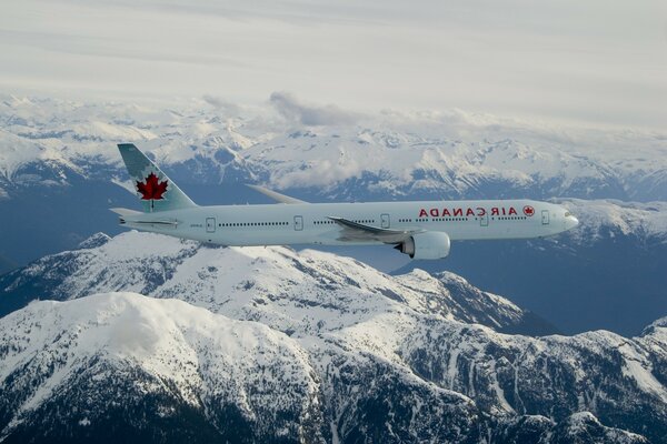 Passenger plane over snowy mountains