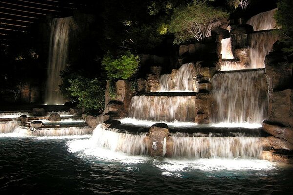 A beautiful large waterfall flows into the river