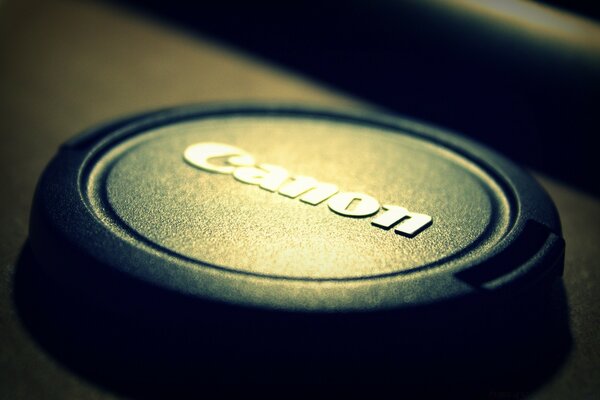 The Canon logo on the button with a beautiful backlight