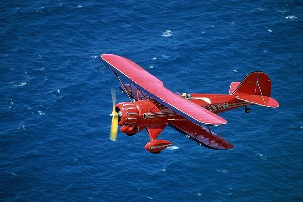 A red airplane. The Blue Sea