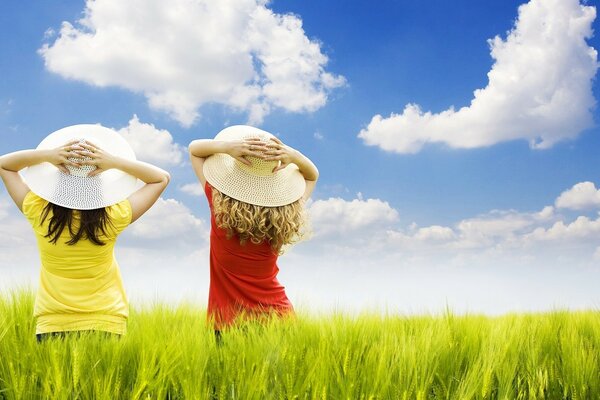 Two girls in the green grass