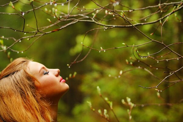 The girl inhales the fragrance of nature