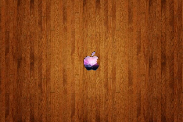 A small colored Apple icon on a wooden background