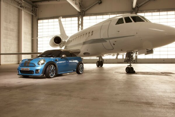 White airplane and blue mini cooper