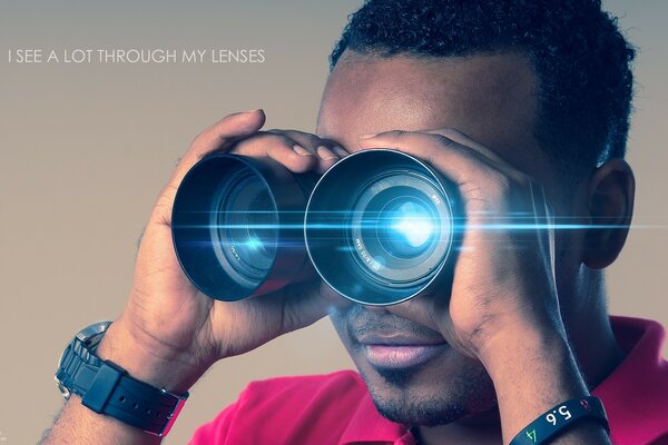 Young man look into the distance with binoculars