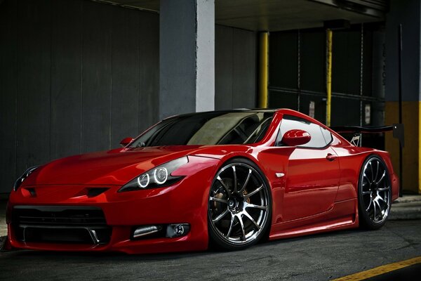 Red sports car in the parking lot