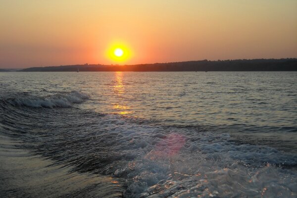 Sunset on the water from a motor boat