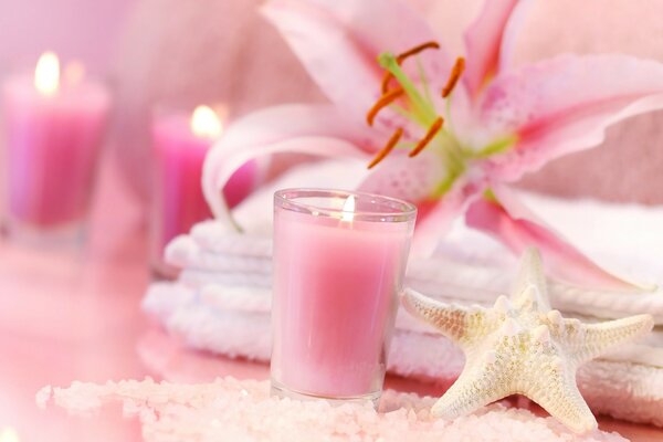 Relaxation. Pink candles and the scent of lilies