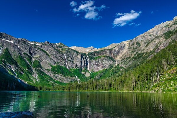 Lake on the background of a mountain and a blue sky