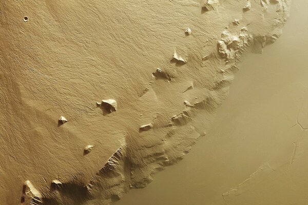 Wet sand on the beach with footprints