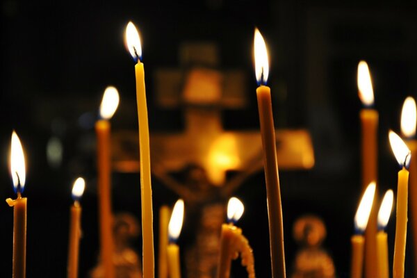 Wax candles are burning in the temple