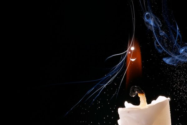 Candle flame with smoke on a black background