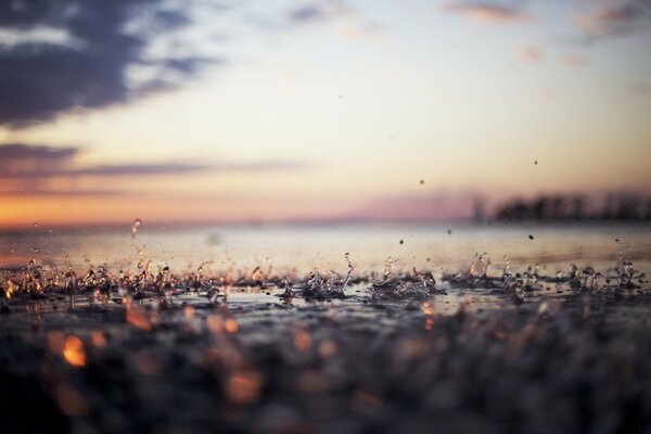 Raindrops on the evening beach are close