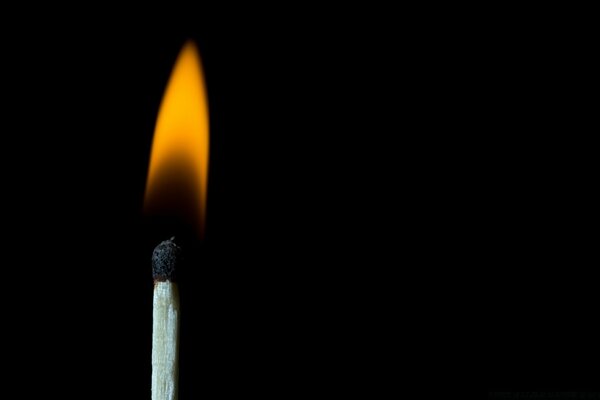 Flame from a match on a black background