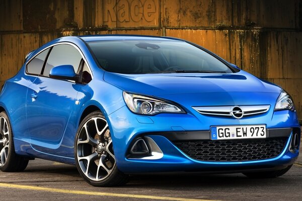 Beautiful blue opel on the background of a grunge wall