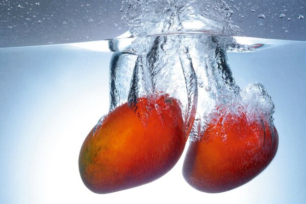 Mango in the water. Fruit Drop