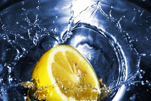 Splashes of water. Yellow lemon