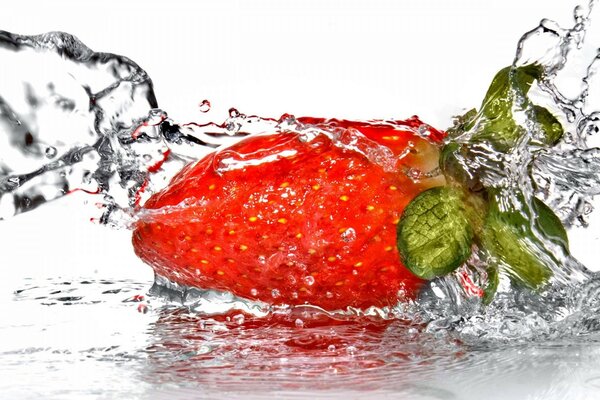 Strawberry, doused with a stream of water. Bursts