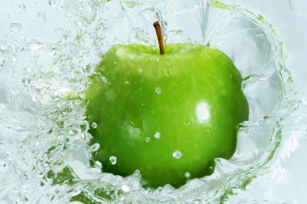 Green apple in clear water