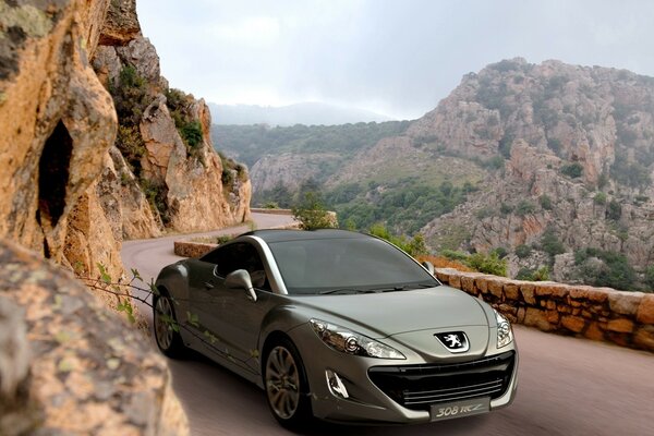 PEUGEOT COUPE ON A MOUNTAIN SERPENTINE