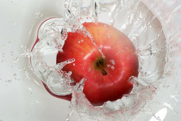 Red apple with splashes of water