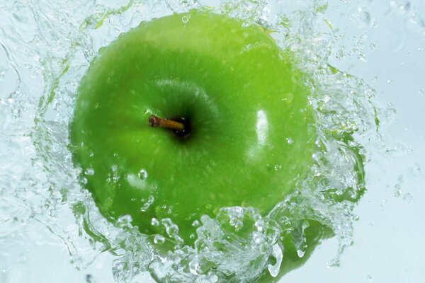 Green apple in clear water