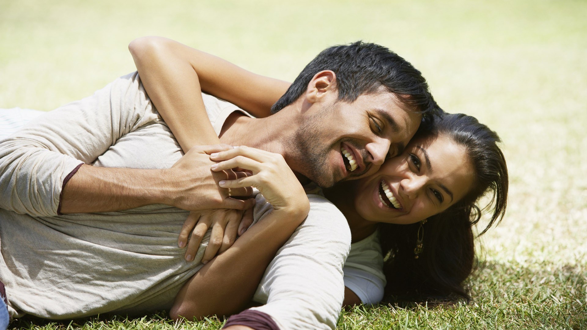 couples outdoors relaxation leisure woman love togetherness affection reclining summer man grass embrace nature romance joy enjoyment