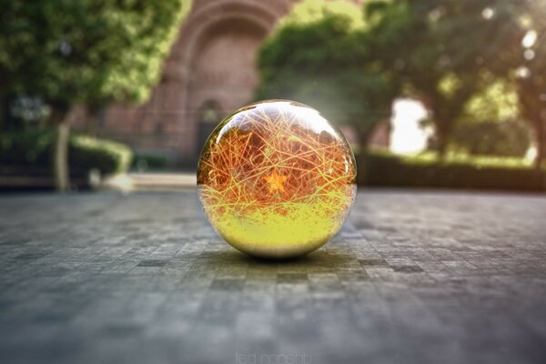 A ball with a piece of magic on a background of trees