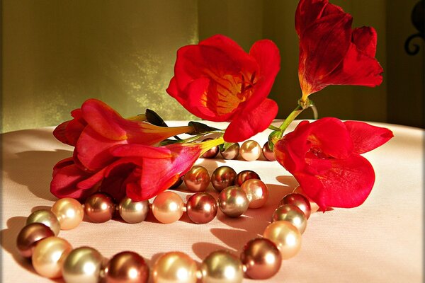 Red freesias and colored pearls