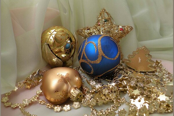 Photos of festive balls of blue and gold on a light background