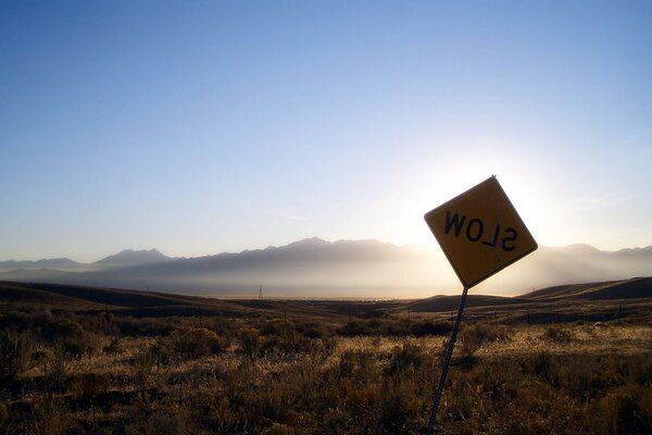 SLOW sign in the desert