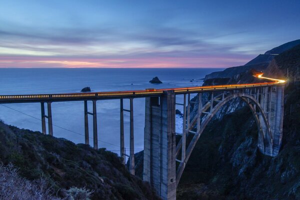 Bridge over the abyss in the evening twilight