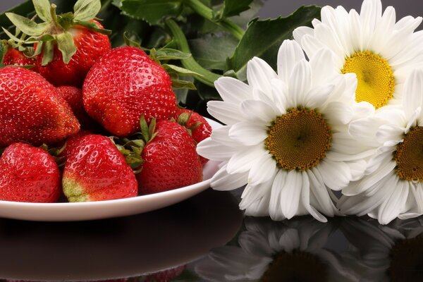 A plate of strawberries and flowers