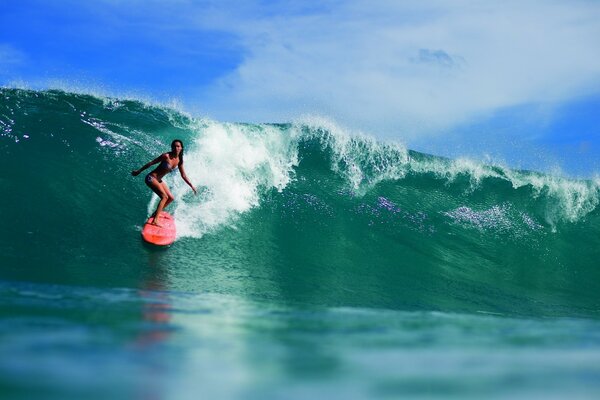 Surfer girl conquers a huge wave