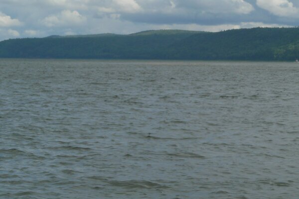 A darkened pond against the background of mountains