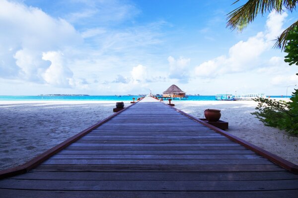 Wooden platform on the beach leading to the sea