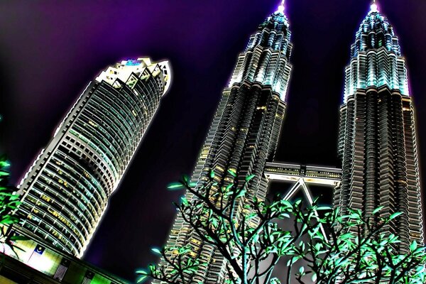 Skyscrapers glowing in the night against the sky