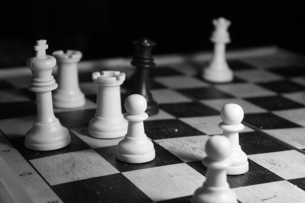 The black king surrounded by white pieces in chess