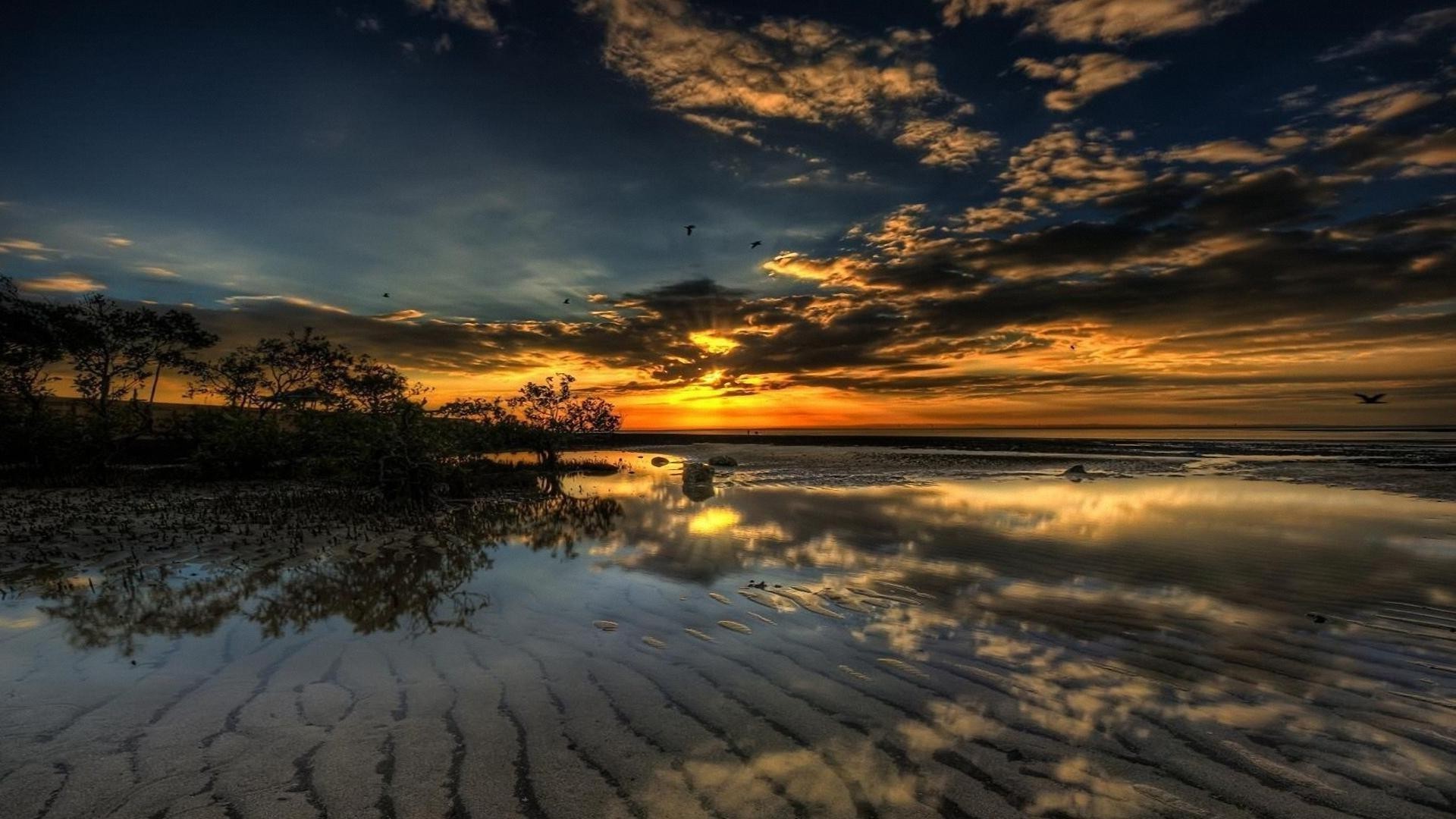 the sunset and sunrise sunset water dawn beach dusk evening sky landscape sun nature ocean sea sand travel reflection seascape