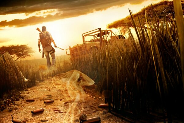 The hero of the game Farcry 4 in full combat gear leaves on the way to his jeep against the background of the sunset sky