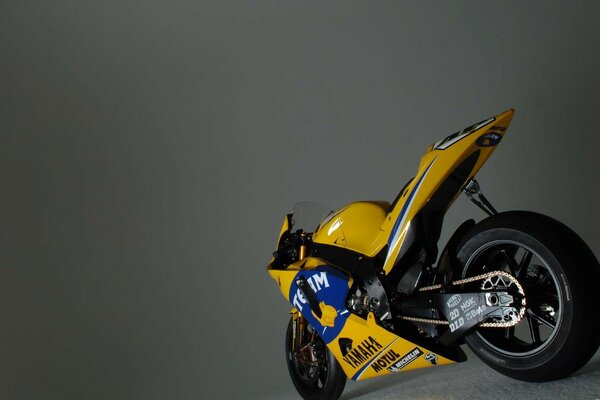 Yellow sports motorcycle on a gray background